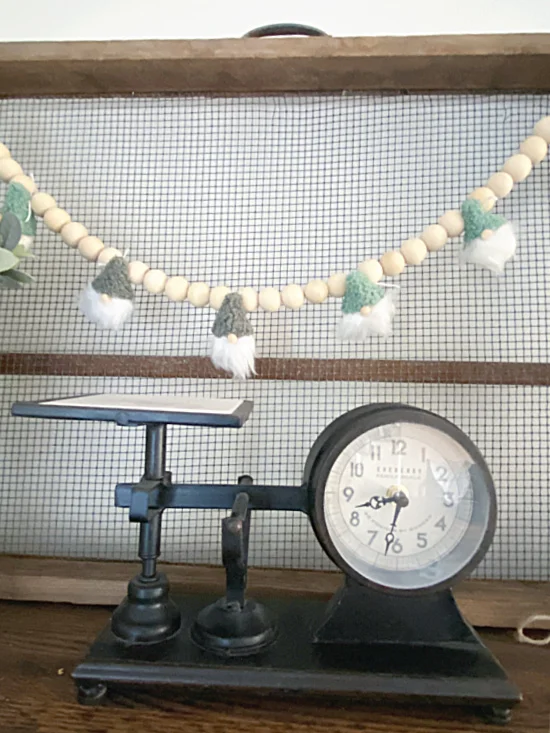 vintage scale and garland with gnomes