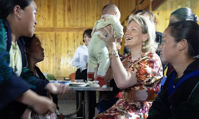 Queen Mathilde wore a new Mayla Chufy floral print dress by Sezane. Caroline Biss belt. Penelope Chilvers