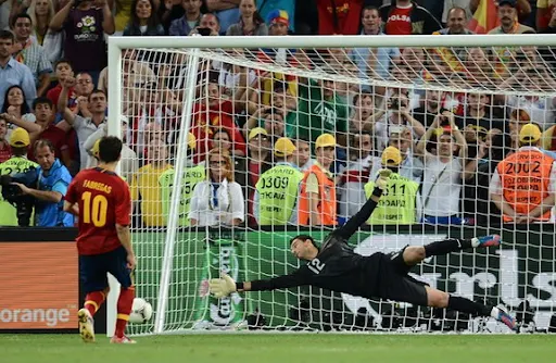 Spanish midfielder Cesc Fàbregas scores the winning penalty past Portuguese goalkeeper Rui Patrício