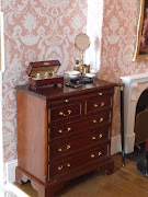 There is a mahogany sleigh bed by Escutcheon, a Queen Anne cupboard by .