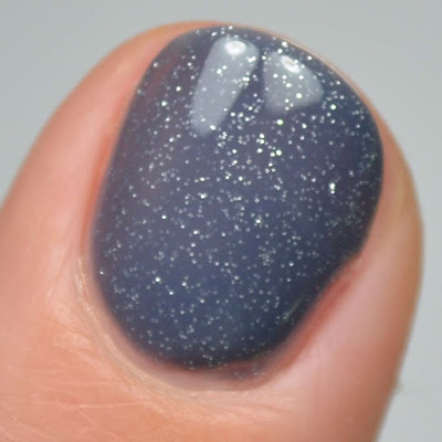 denim blue nail polish with silver glitter swatch