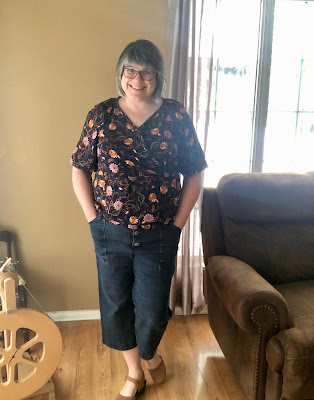 Navy floral top shown loosely tucked in, with cropped Lander jeans and clogs