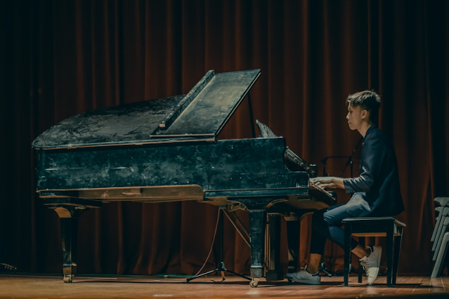 man playing grand piano