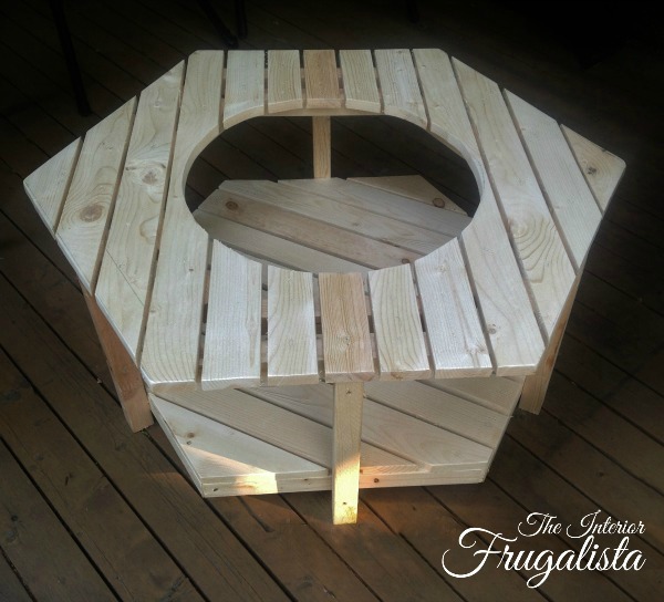 A budget-friendly DIY Adirondack Fire Bowl Coffee Table for a patio or deck with a unique hexagon pallet style for those cool summer evenings outdoors.