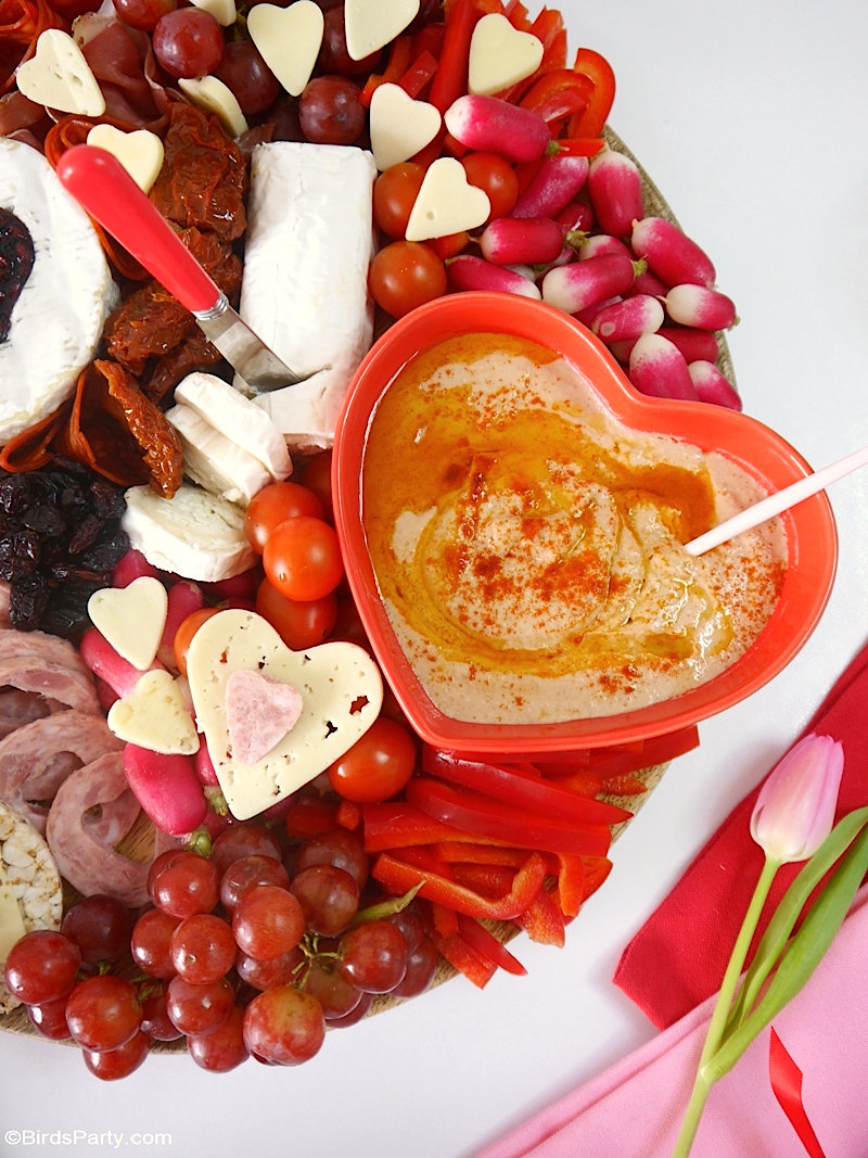 Valentine's Day Cheese and Charcuterie Board - easy, pretty, delicious grazing board filled with pink & red foods to celebrate love day at home! by BirdsParty.com @birdsparty #cheeseboard #charcuterieboard #valentinesday #recipes