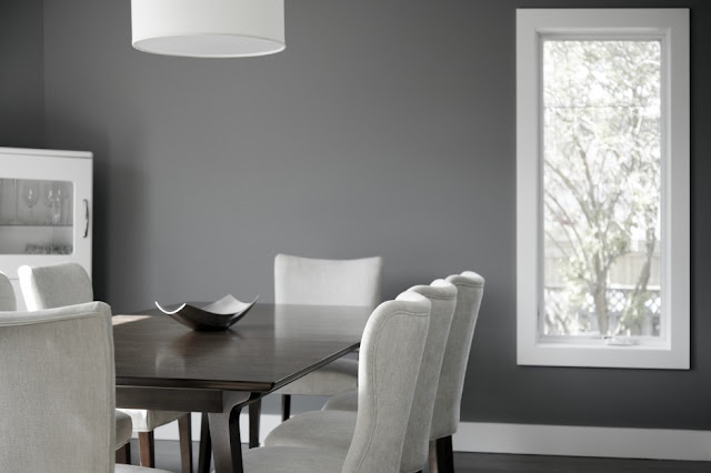 Picture of dark brown minimalist dining table with light grey chairs in the dining room