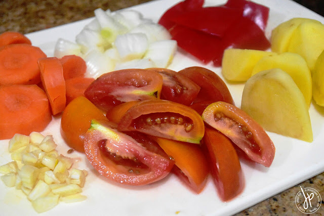 Vegetables for Chicken Afritada: garlic, carrots, onion, bell pepper, potatoes, tomatoes