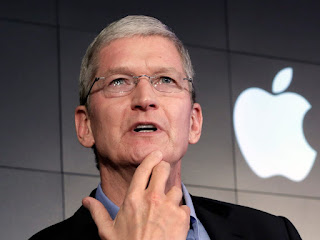 A headshot of Tim Cook, CEO of Apple Inc. He is smiling and looking directly at the camera.