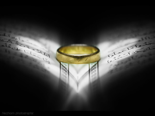 gold ring on AlQuran with love light