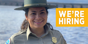Woman wearing state parks uniform with we're hiring