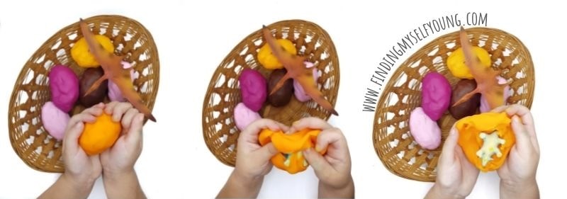childs hands opening playdough eggs