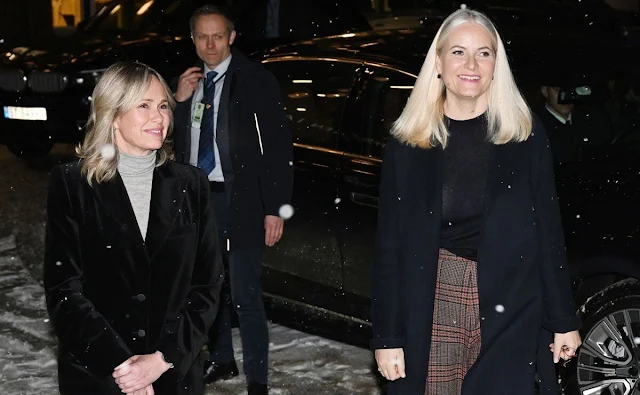 Crown Princess Mette-Marit wore a black cashmere sweater, and navy wool coat. Prince of Wales checked pants