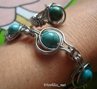 twice around the world (TAW) wire wrap bracelet and ring on wrist and finger