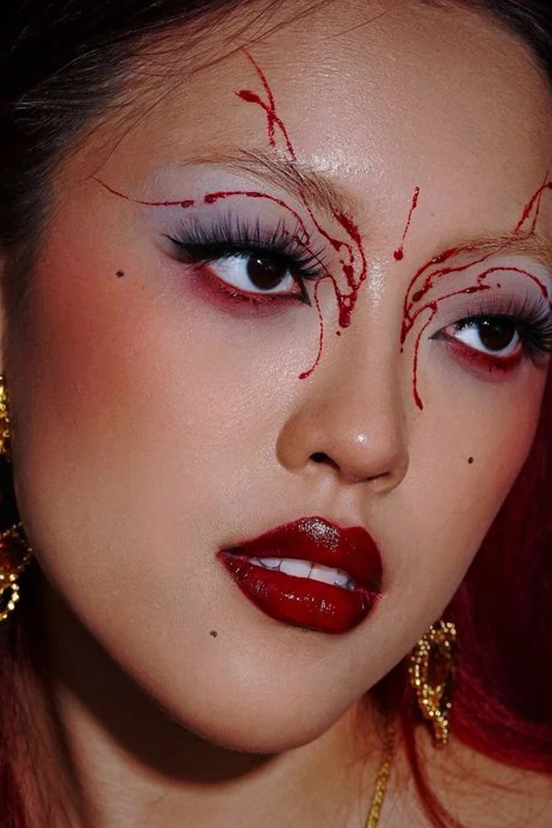 close-up selfie of a beautiful woman with reg goth makeup look