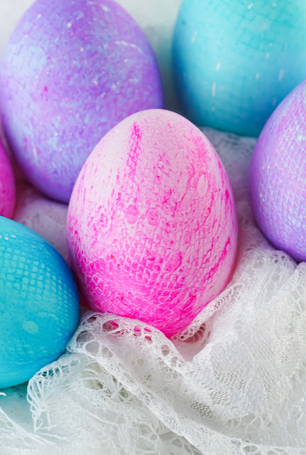 dyes eggs displayed on white lace.