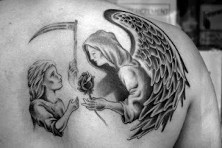 Angel of Death tattoo on the back: the Angel of Death offering a rose to a child