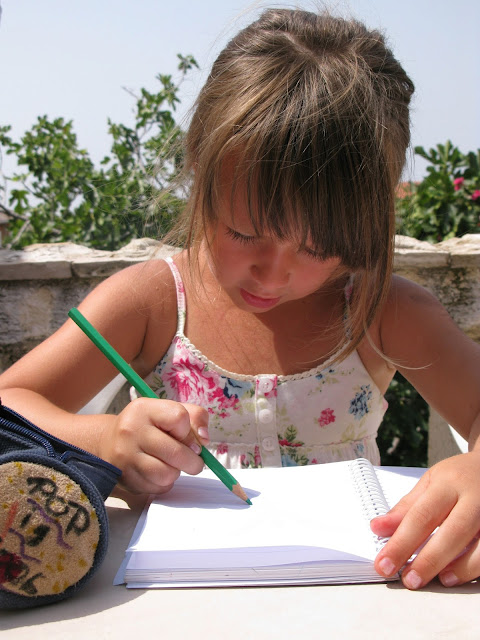 NAMC should we still teach handwriting in the Montessori classroom girl writing