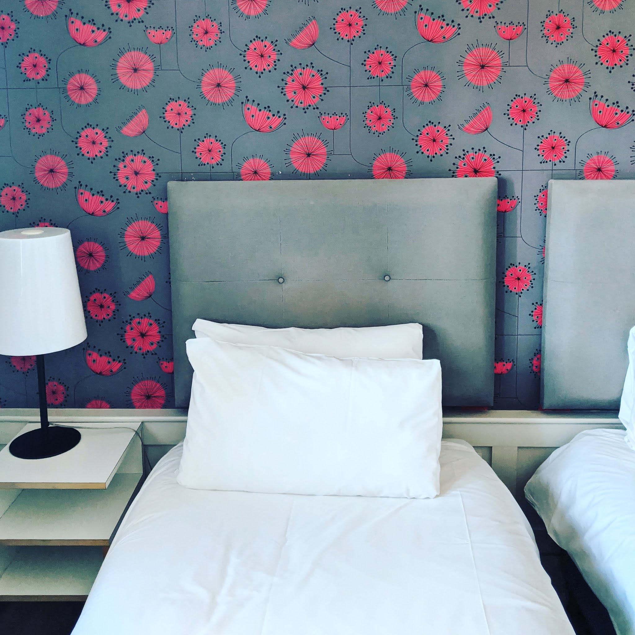 bed with poppy wallpaper at grasshoppers hotel