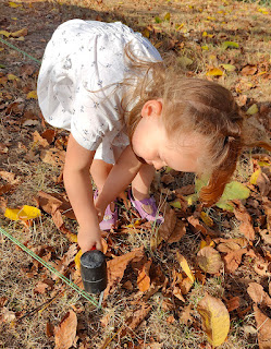 Rosie hammers a tent peg in