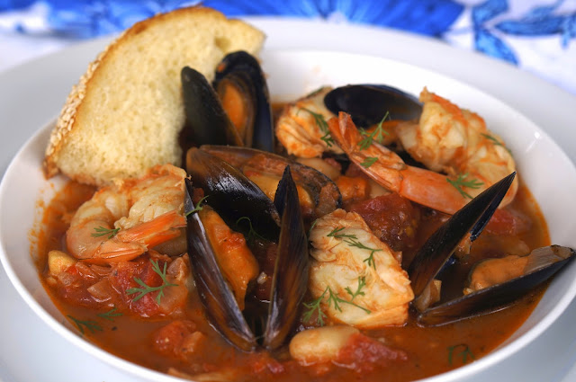 spicy fish stew, fire roasted tomatoes, garlic, crushed red pepper, cilantro, lemon peel, halibut, shrimp, gantry bay seafood mussels in a garlic butter sauce