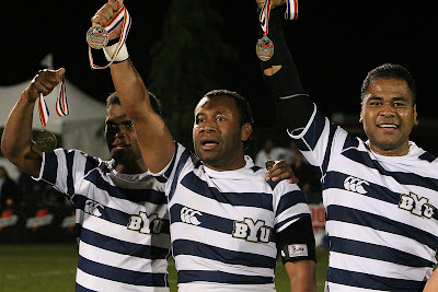 BYU Rugby players, Isi, Vito, and Pila, hoist their gold medals high