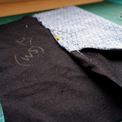 Wrap the larger seam allowance round the smaller one and stitch down.