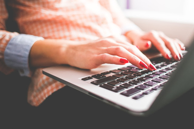 girl sitting and working on a laptop