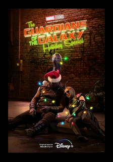 Drax and Mantis passed out while laying on a parking meter. Drax is wearing a Santa hat and Mantis is wearing sunglasses, and they're both tangled in Christmas Lights. Behind them is "The Guardians of the Galaxy Holiday Special" on the wall.