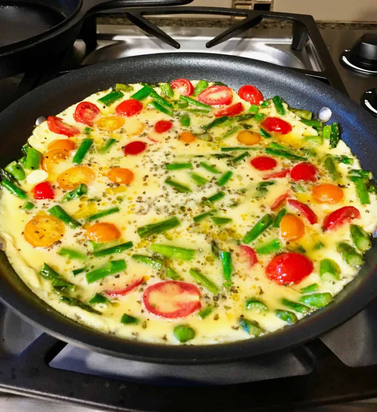 Asparagus Frittata cooking in a skillet.