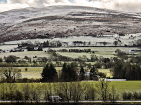 Photo of the A66 Workington to Keswick road with snow on the hills beyond