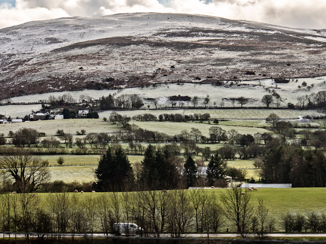 Photo of the A66 Workington to Keswick road with snow on the hills beyond