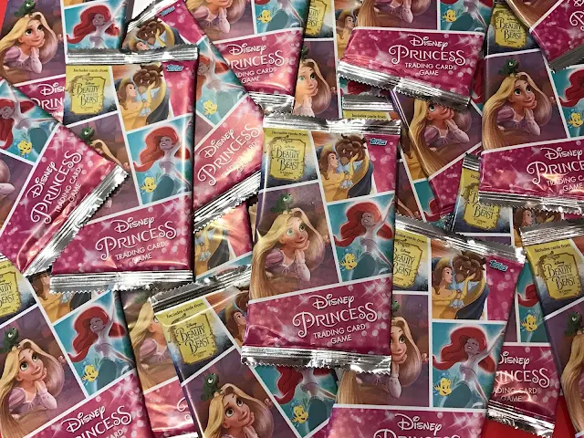 A mess of small packs of Topps Disney Princess Trading Game