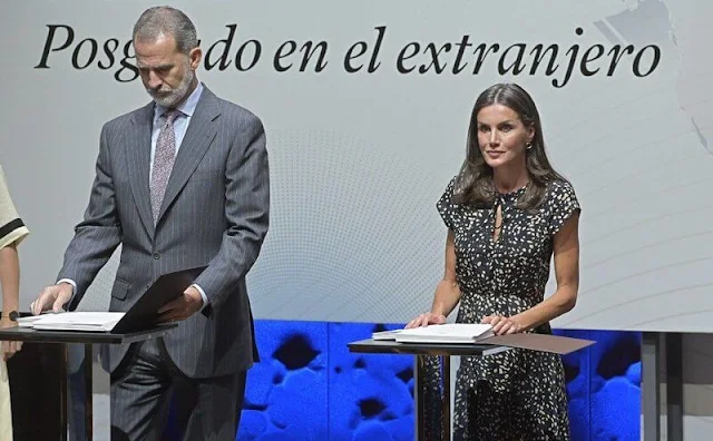 Queen Letizia wore an animal print midi dress by Massimo Dutti. Letizia wore black suede espadrille wedges by Macarena