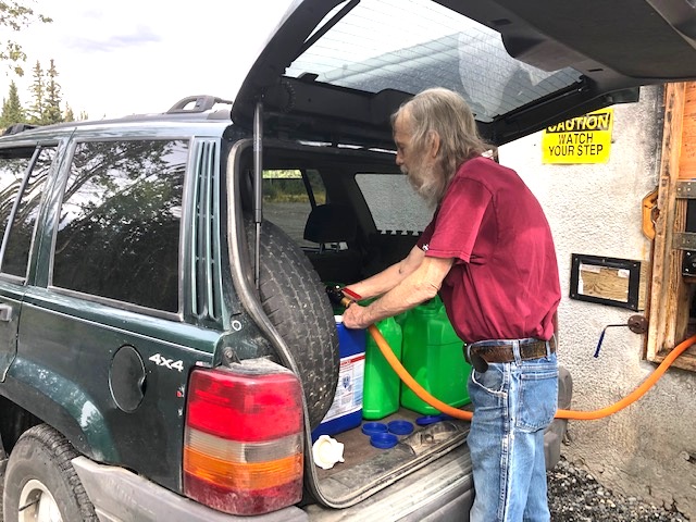 Plastic water jugs filled with water in the back of an Alaskan vehicle, 2020 