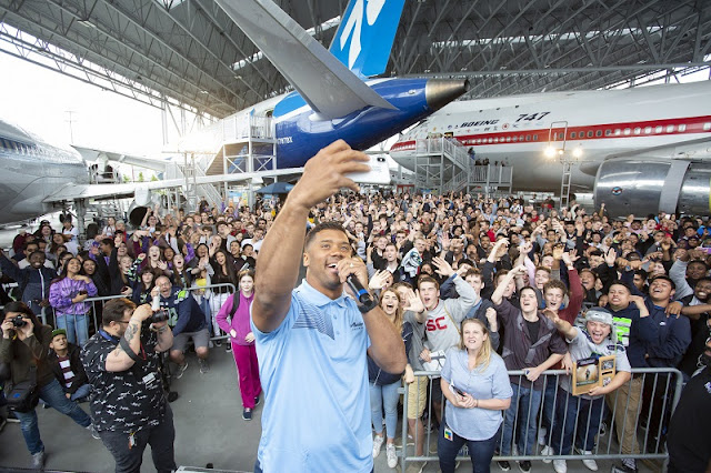 7m7a7040 Dream Big, Fly High: What Russell Wilson’s new plane is all aboutRussell Wilson with high school graduates at Alaska Airlines’ There’s No Time to Sleep event. Credit: John Lok