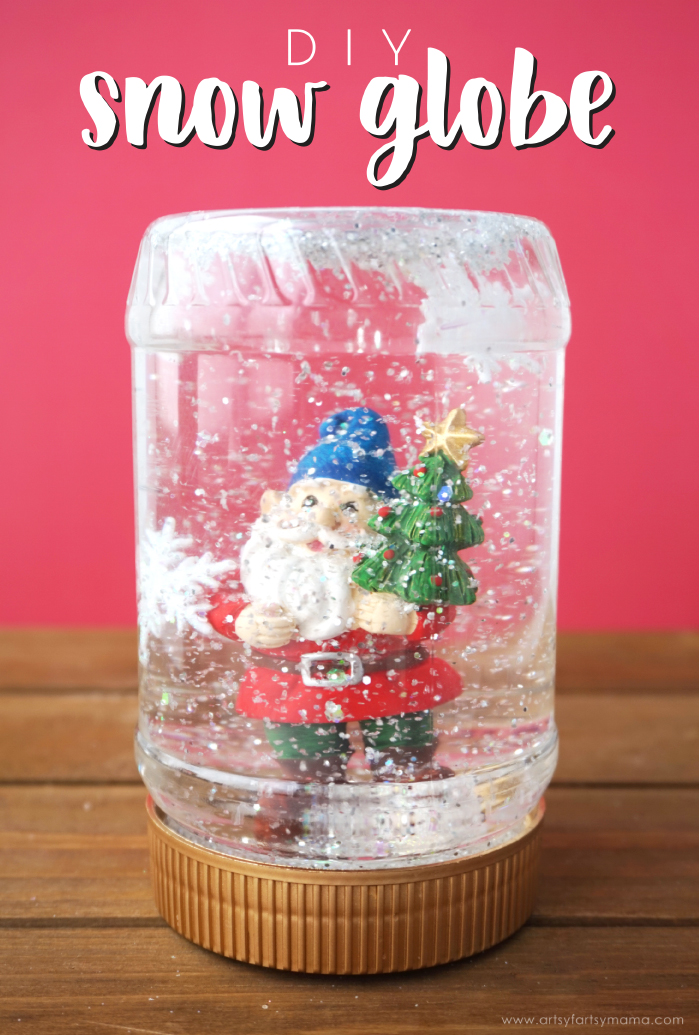 Upcycle a peanut butter jar to create your own DIY Snow Globe winter wonderland!