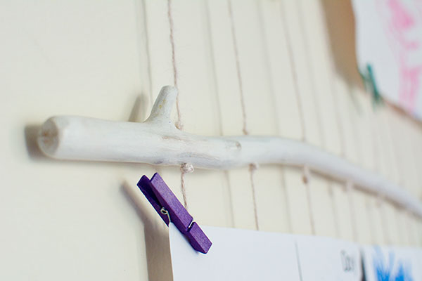 Purple clothespin holding up child's artwork.