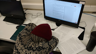 Deal is pictured with her head on the desk, surrounded by various paperwork, a computer.