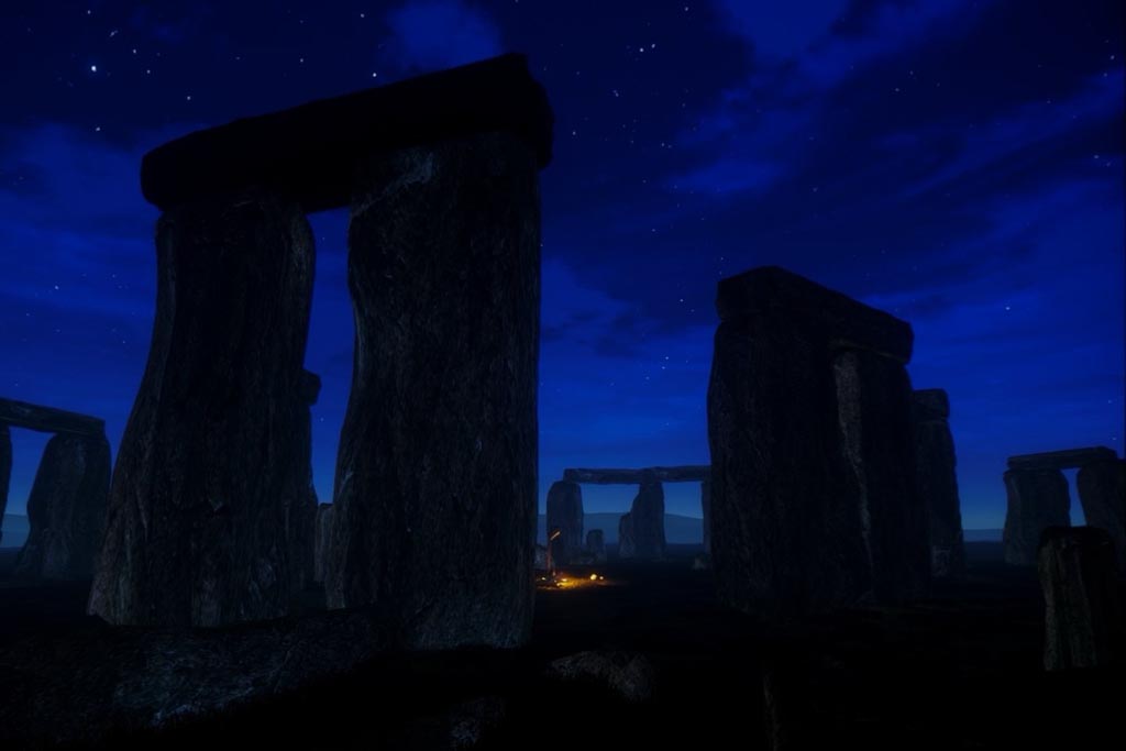 Dark silhouettes of the famous stones, with a dark deep blue starry night sky behind.
