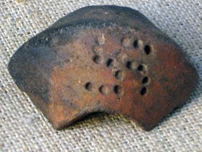 Pottery fragment with a swastika, said to be from the Trypillia culture in Ukraine.