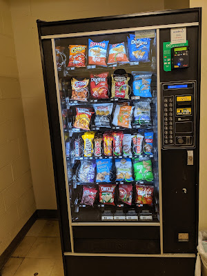 Photo of a Vending Machine with an alphanumeric keypad. various snacks 