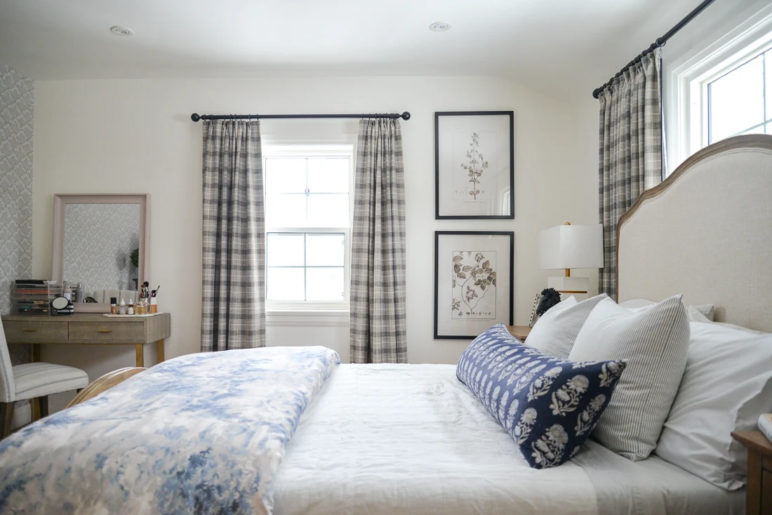 grey white and blue toile duvet on bed in white bedroom with grey curtains