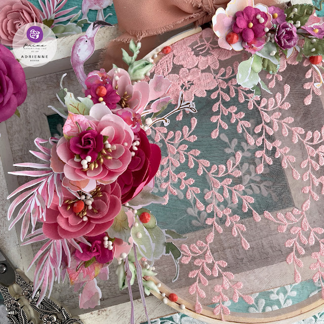 Altered embroidery hoop created with: Prima Marketing. Postcards from Paradise lace, floral ephemera, paper flowers (may flowers, aloha, blissful day), moulds, say it in crystals, Finnabair art stones, impasto paint, Art Philosophy, metallic pastel accents watercolors