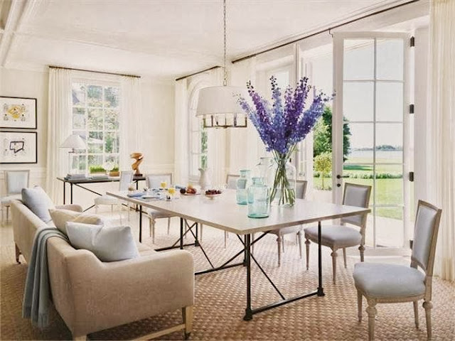 Elegant and inviting dining room in Villa Maria with french doors, carpeted floor, white pendant light and a sofa