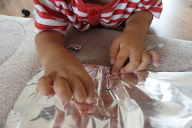 Child playing with tin foil