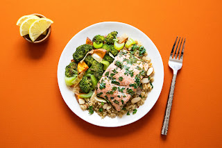 a plate of salmon and vegetables