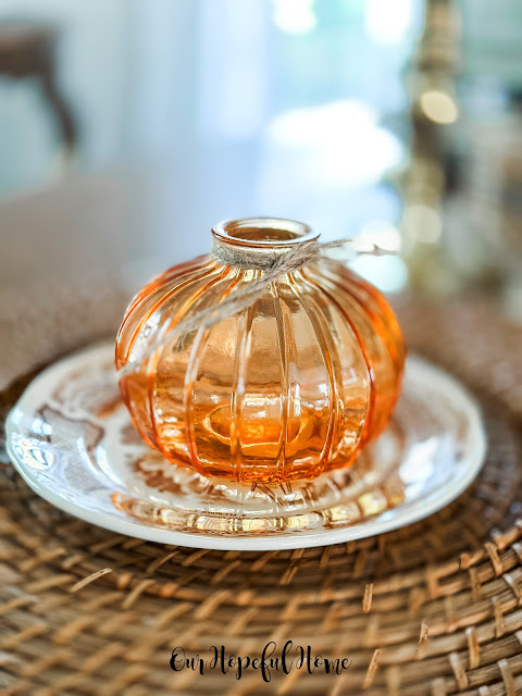 orange pumpkin shaped vase on dessert plate