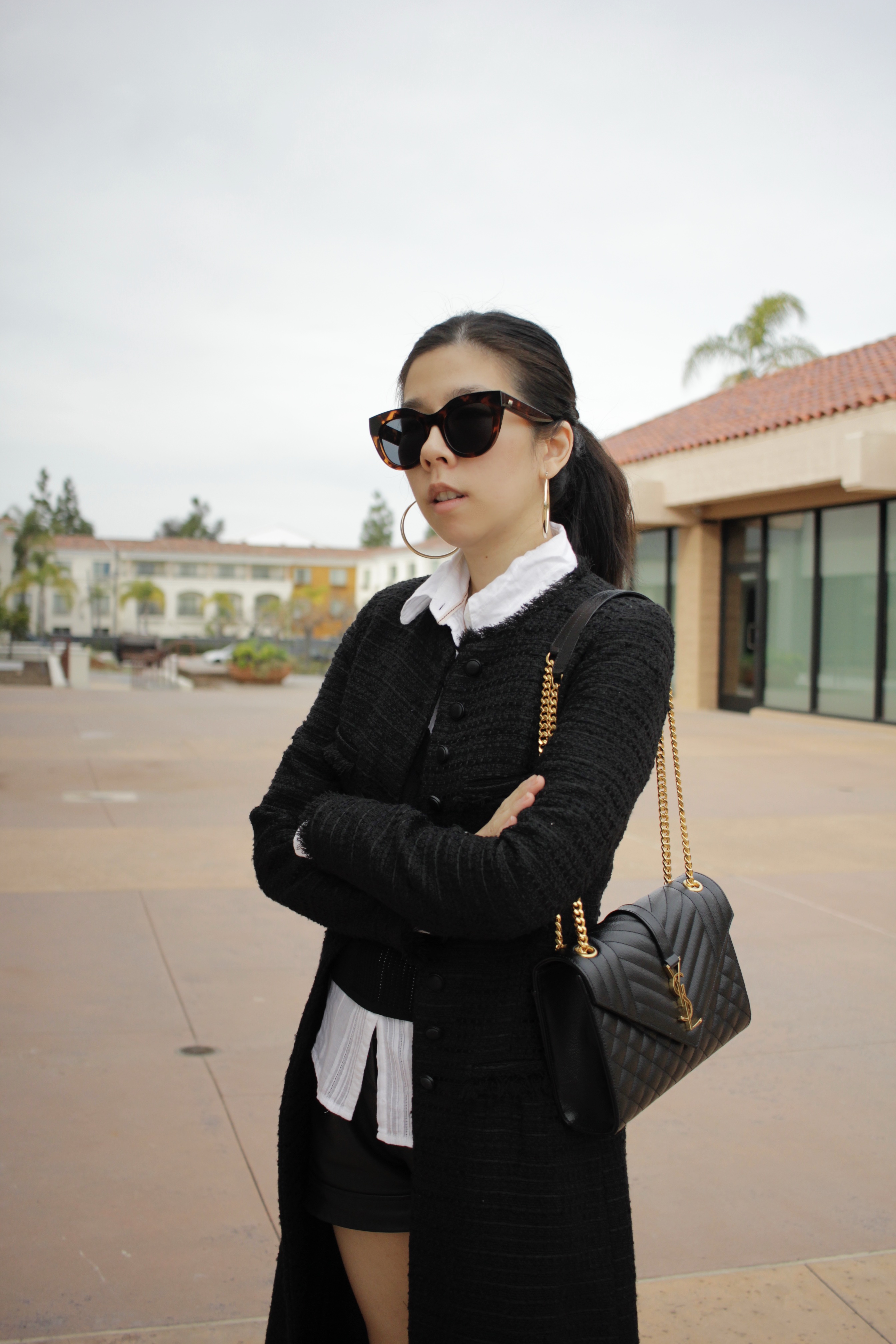 Adrienne Nguyen_Minimalistic Casual Old Money Black and White Outfit_Tweed Coat_Sweater Vest_YSL Saint Laurent Medium Envelope_Leather Shorts_J/Slides Amanda Suede Black and White Platform Sneakers