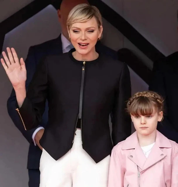 Princess Charlene wore a black zipped jacket by Akris. Princess Gabriella wore a zipped biker pink jacket by Polo Ralph Lauren