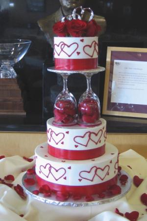 This wedding cake is iced in white buttercream and accented with a double 